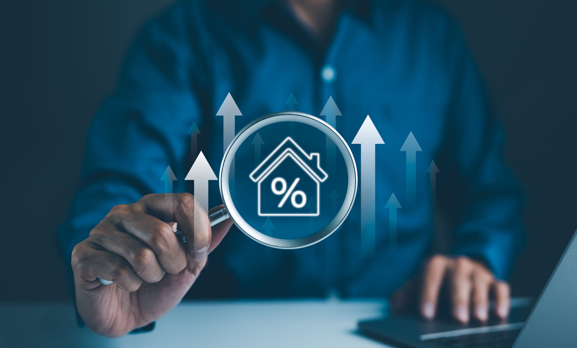 Real Estate Investment Concept. A businessman using a magnifying glass to examine a house icon with a percentage sign, representing real estate investment analysis and market trends.